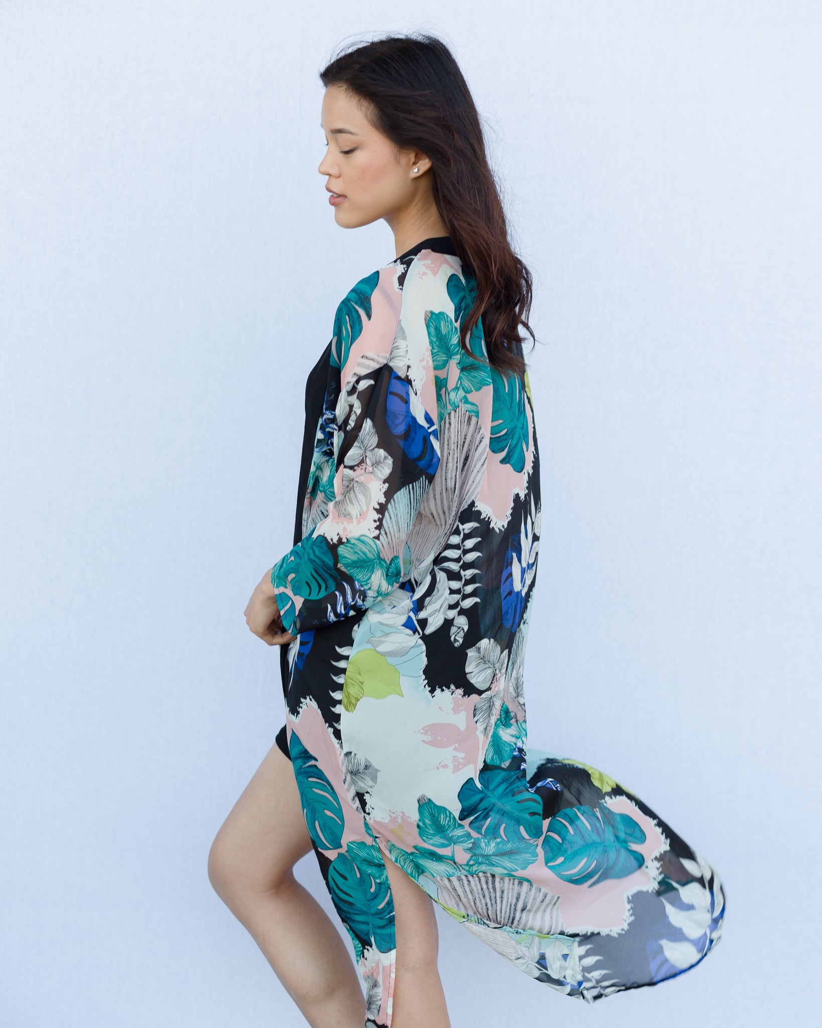 Woman standing with white background wearing long floral boho kimono beach cover up, Shop T.K.S