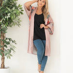 woman in open blush pink kimono and loungewear