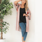 woman in open blush pink kimono and loungewear