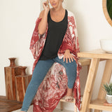 woman wearing white and red floral beach cover up with jeans and black tank top