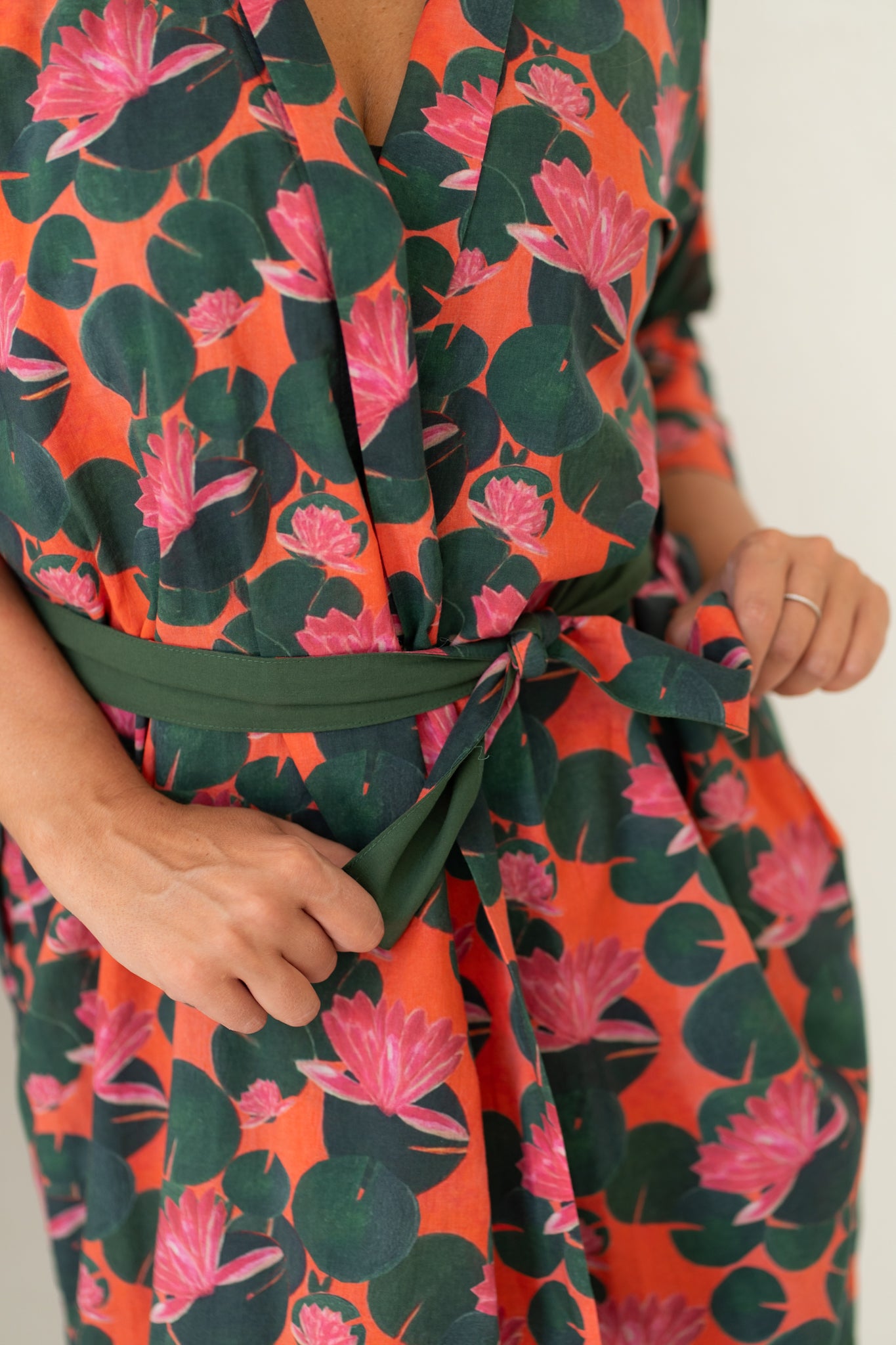 Woman's closeup of pink and green waterlily organic cotton print robe, Shop TKS