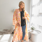 Woman wearing Orange and pink leopard print beach cover up, Shop TKS