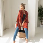 Woman wearing orange sweat for Fall with black bamboo tank top, jeans, bamboo jute handbag, Shop T.K.S
