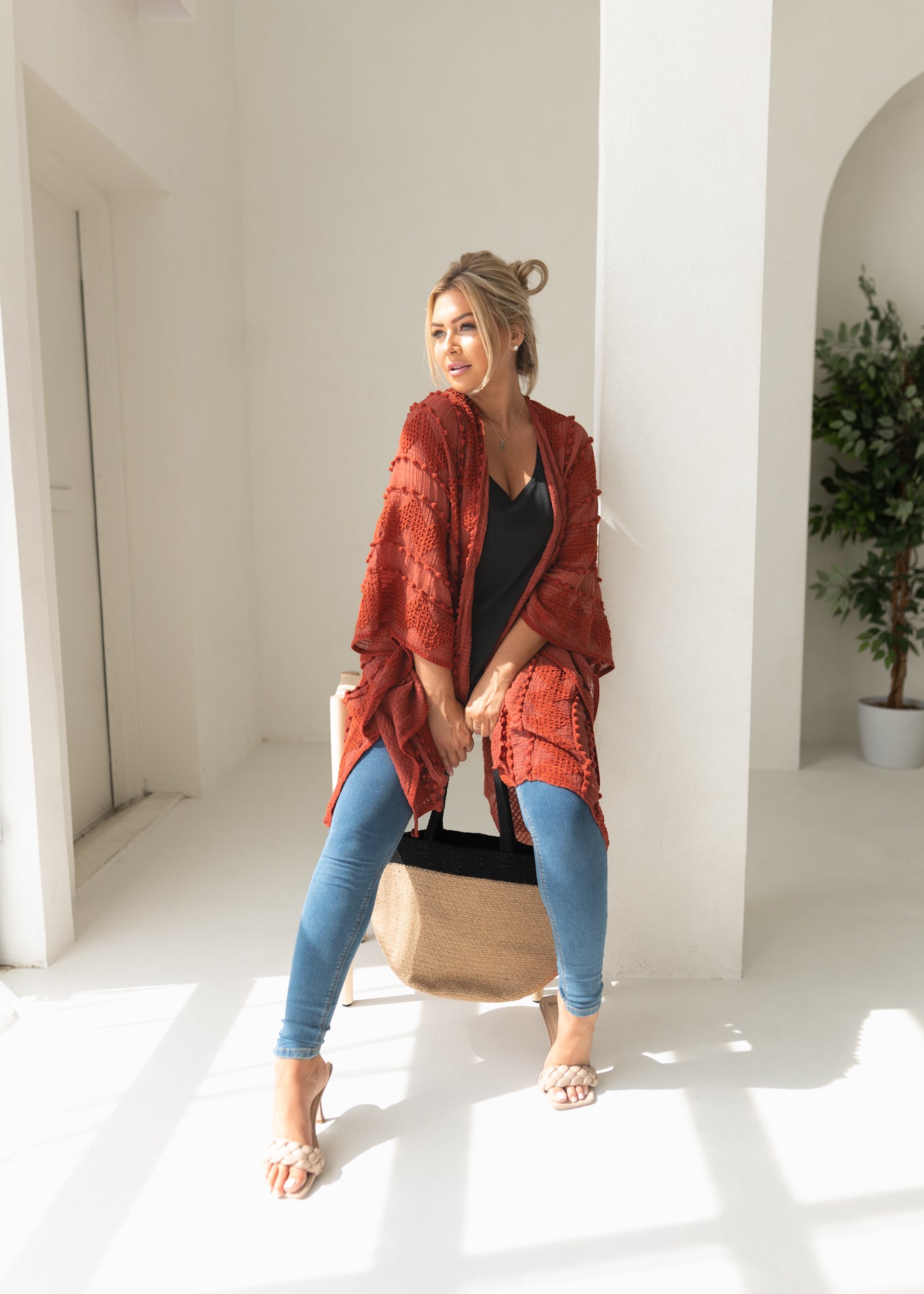 Woman wearing orange sweat for Fall with black bamboo tank top, jeans, bamboo jute handbag, Shop T.K.S