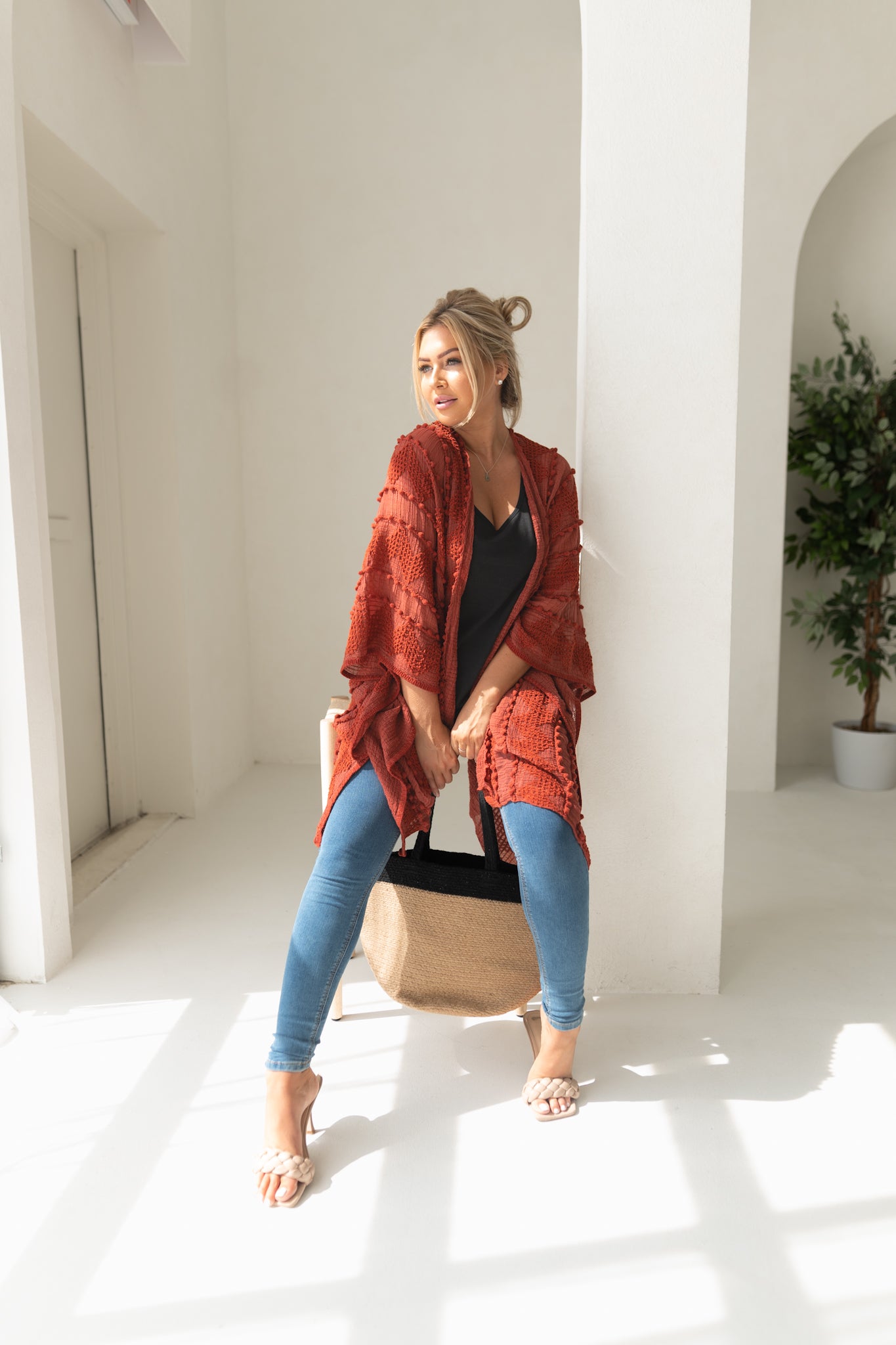 Woman wearing orange sweat for Fall with black bamboo tank top, jeans, bamboo jute handbag, Shop T.K.S