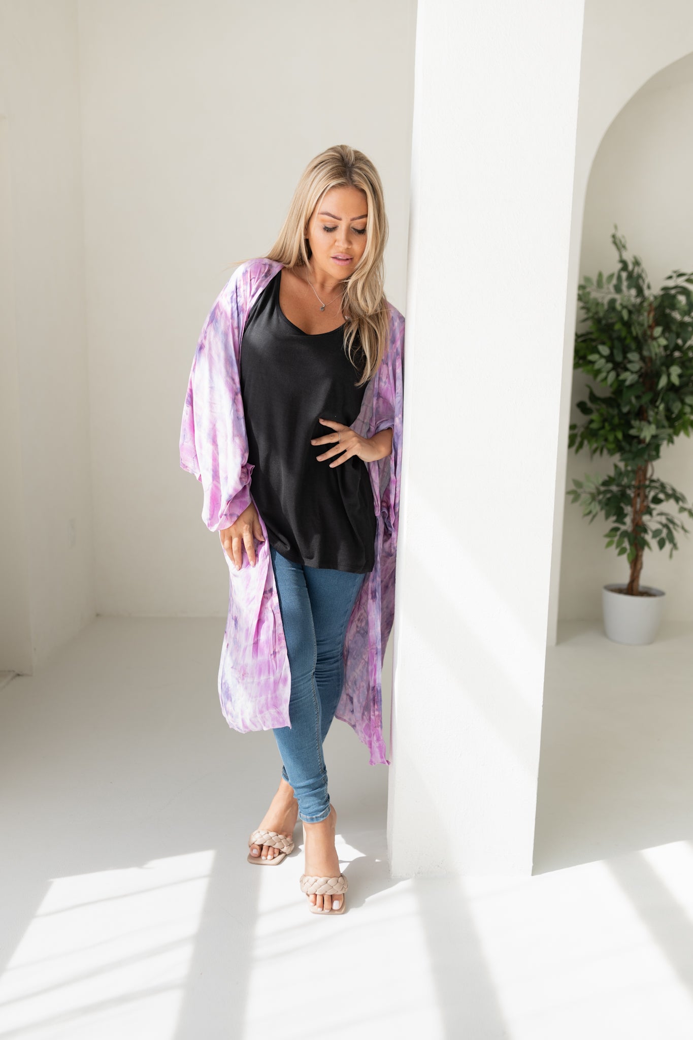 Woman wearing purple tie dye beach cover up, Shop TKS, looking down