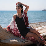 women sitting on log wearing long white and red floral long kimono beach cover up shop tks