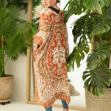 Woman wearing boho orange and cream print beach cover up, Shop T.K.S