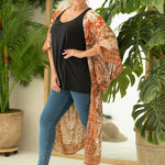 Woman wearing boho orange and cream print beach cover up, Shop T.K.S, front