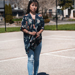 Woman wearing navy blue floral short beach cover up and bamboo tank top with jeans, Shop TKS