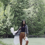 Video of model wearing black and white striped beach cover up with orange lounge pants and bamboo crop top, Shop T.K.S