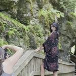 video of woman posing in black and floral velvet cover up