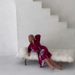 video of woman posing in burgundy kimono robe