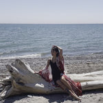 video of woman sitting on log wearing long white red floral beach cover up shop tks