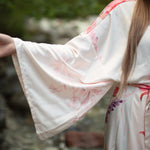 Close up of women's kimono sleeve robe with florals, Shop T.K.S