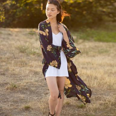 Woman standing in sunset wearing flowy floral long beach kimono cover up, Shop T.K.S