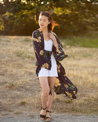 Woman standing in sunset wearing flowy floral long beach kimono cover up, Shop T.K.S