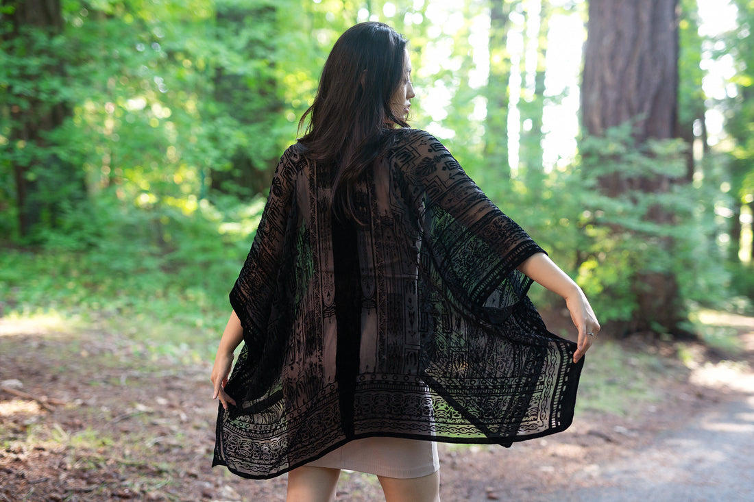Girl wearing black velvet boho short kimono standing in forest, Shop T.K.S