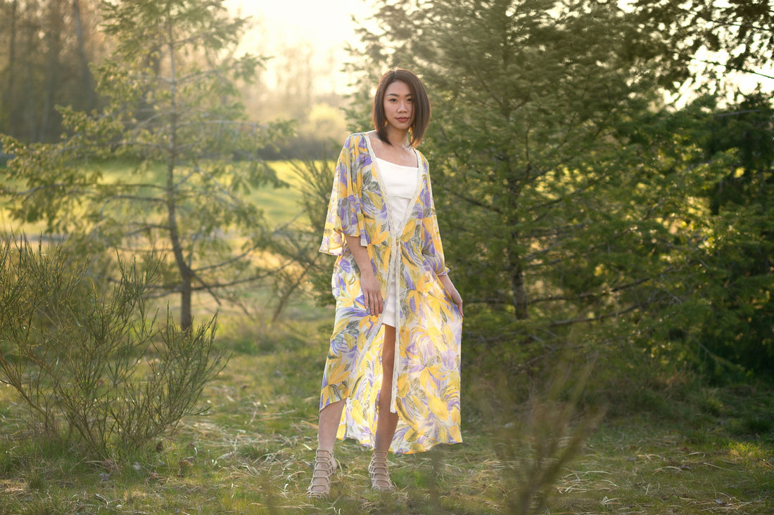 Woman wearing long floral kimono dress in forest, Shop T.K.S