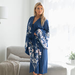 Woman standing near couch wearing plus sized navy blue floral kimono robe, Shop TKS
