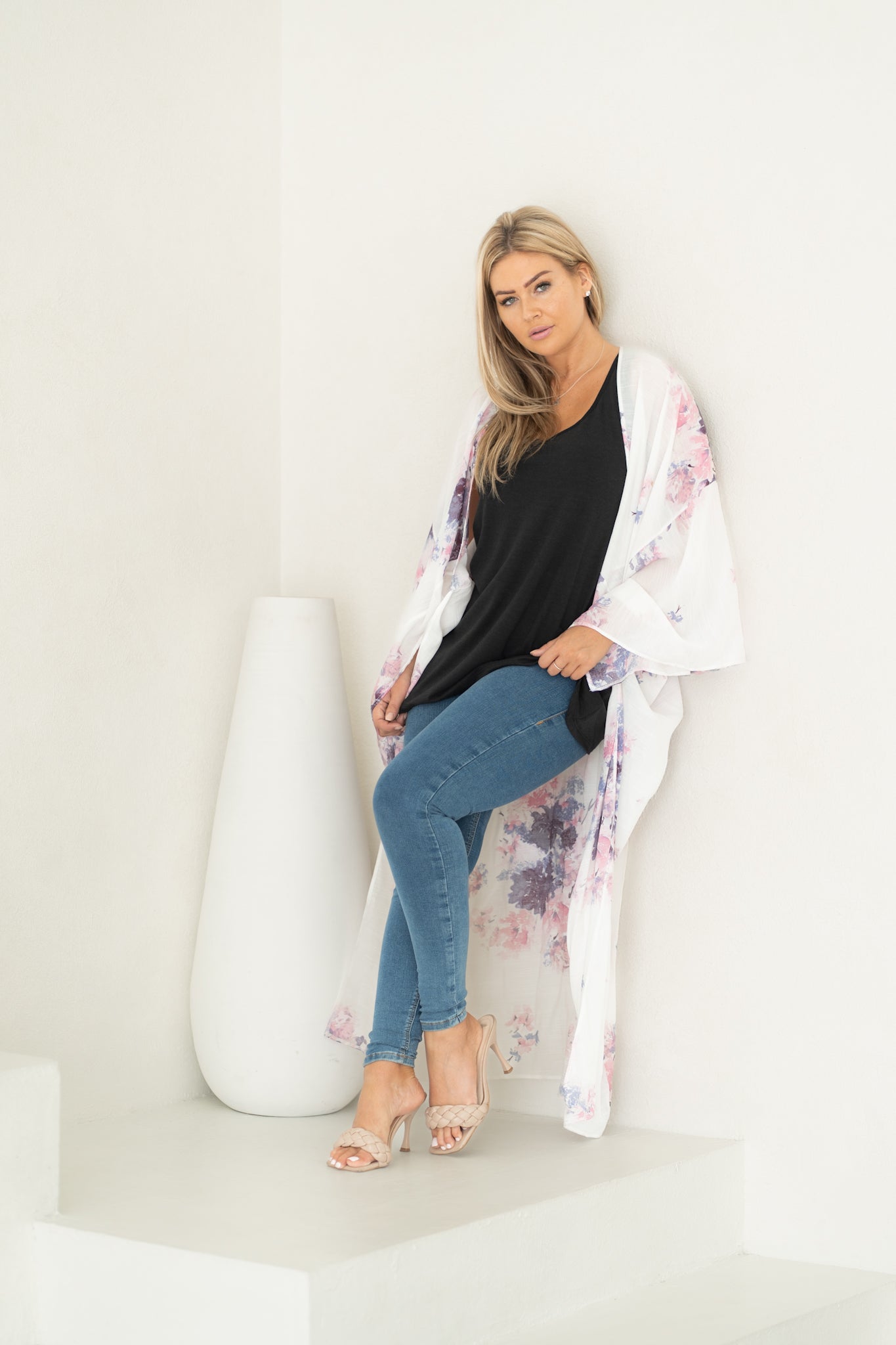 Woman sitting wearing white floral beach cover up, bamboo tank top and jeans, Shop T.K.S