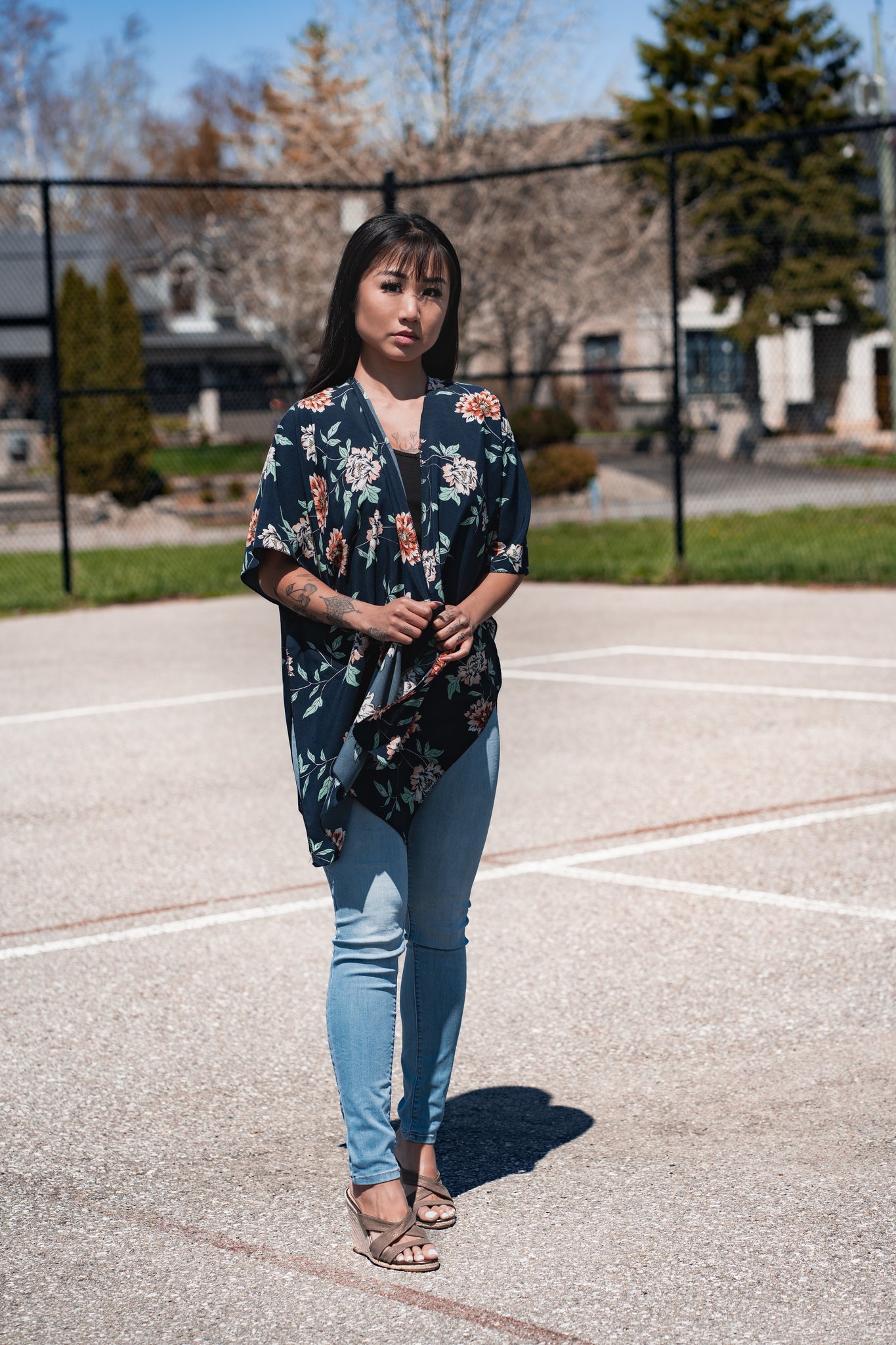 Woman wearing navy blue floral short beach cover up and bamboo tank top with jeans, Shop TKS