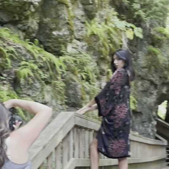 video of woman posing in black and floral velvet cover up