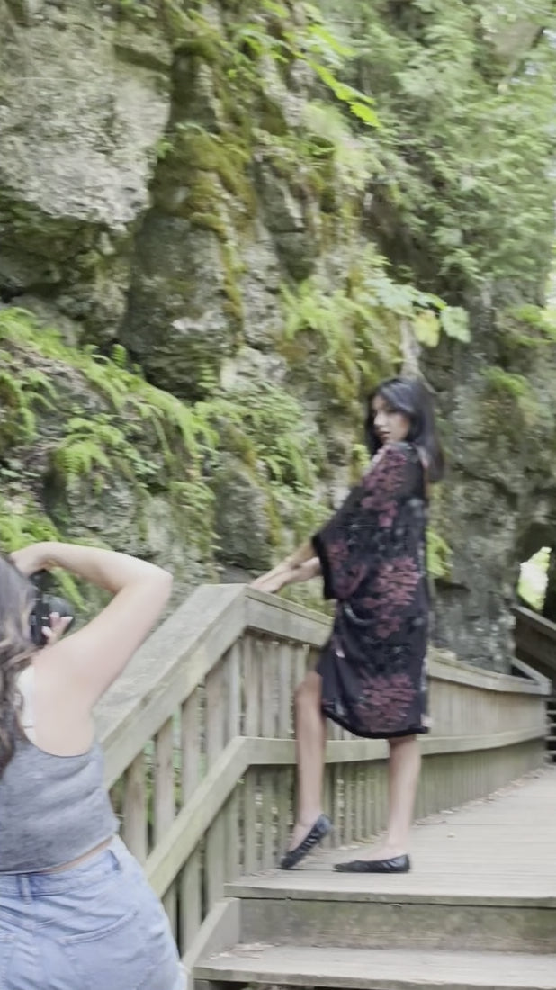 video of woman posing in black and floral velvet cover up