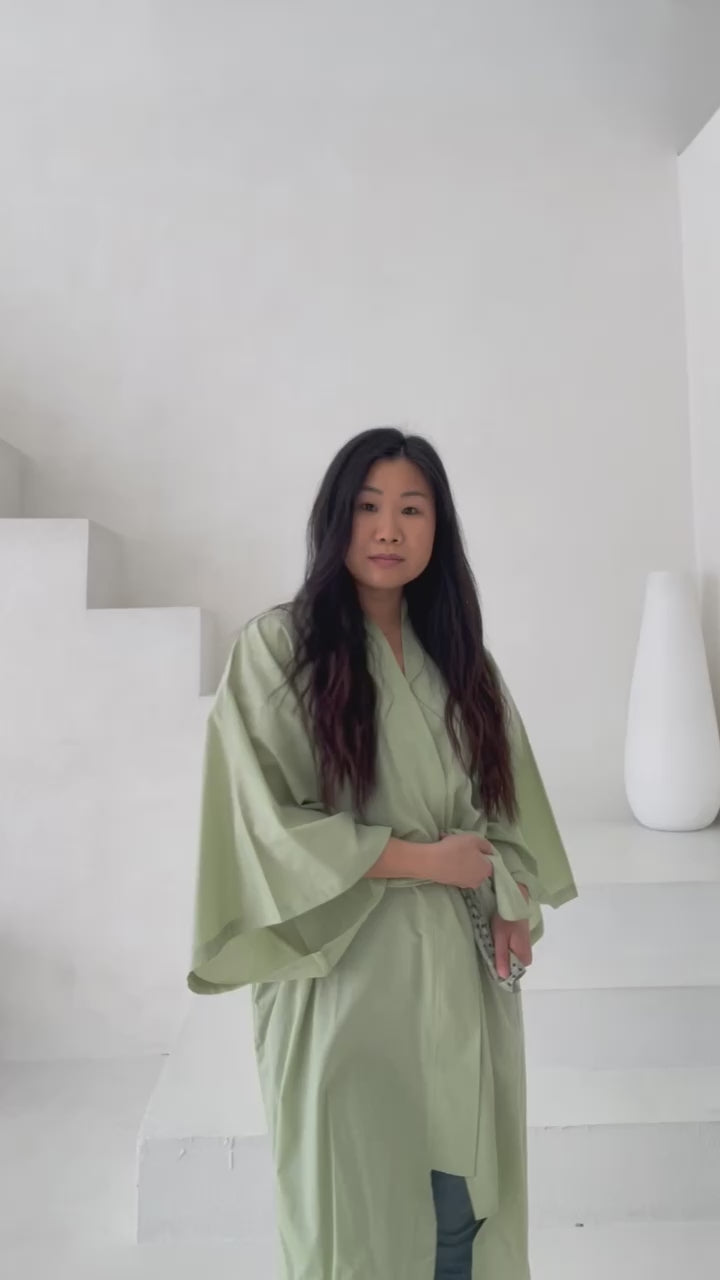 video of woman posing in green kimono